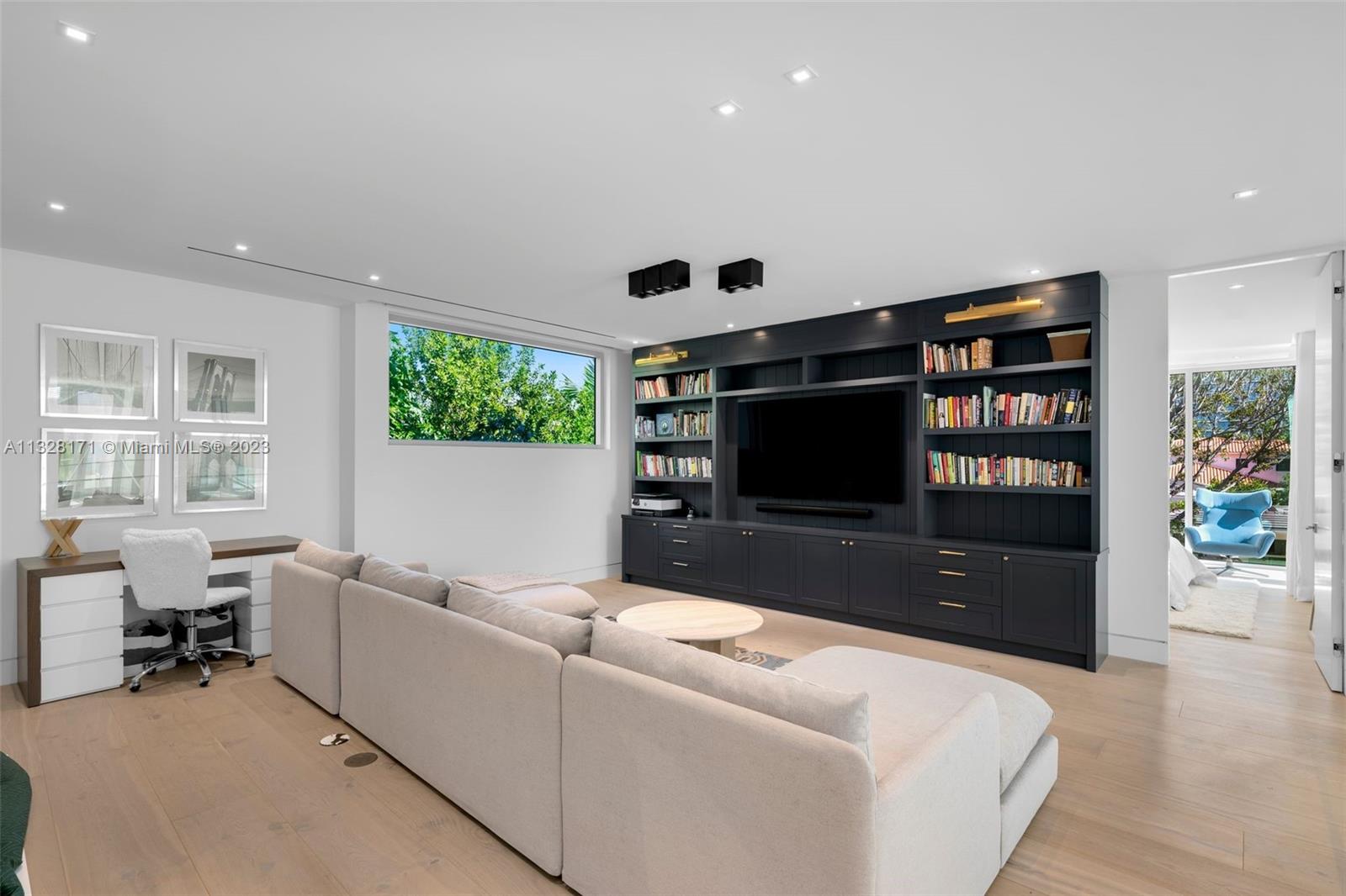 390 Pacific Road Key Biscayne, FL 33149 - Photo 11 of 37 a living room with furniture and a flat screen tv