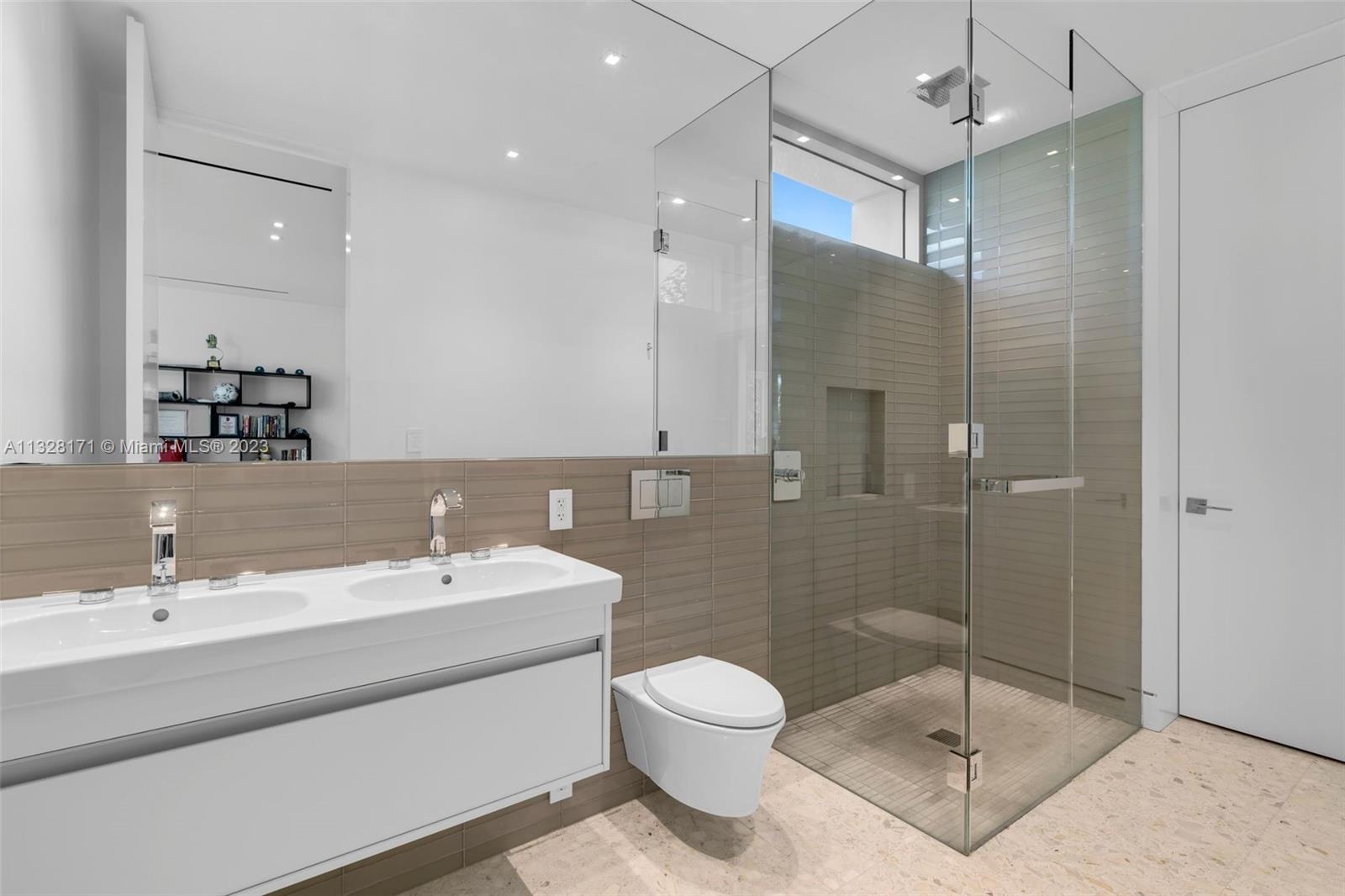 390 Pacific Road Key Biscayne, FL 33149 - Photo 20 of 37 a bathroom with a toilet sink and shower