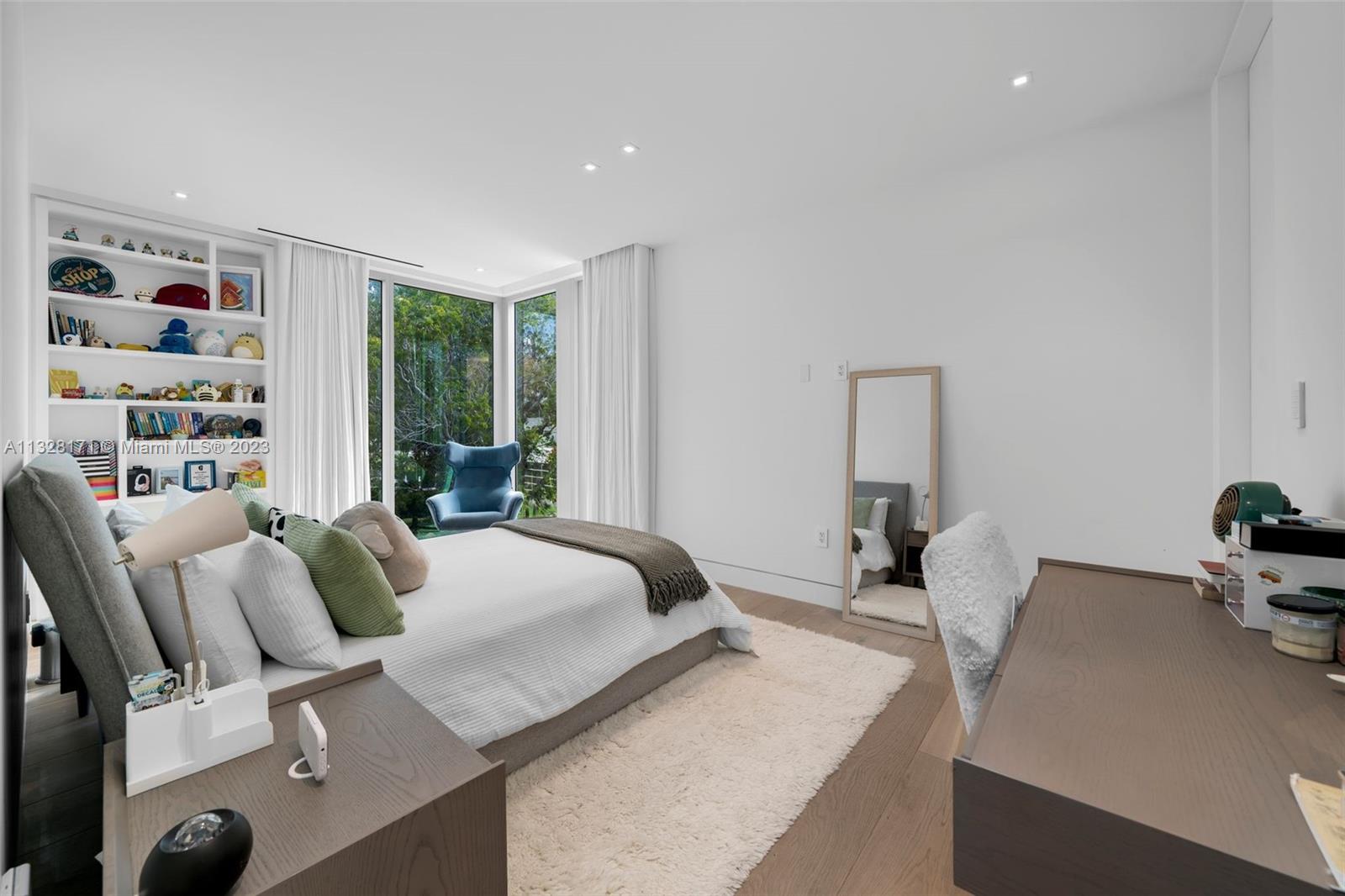 390 Pacific Road Key Biscayne, FL 33149 - Photo 21 of 37 a bedroom with furniture and a large window