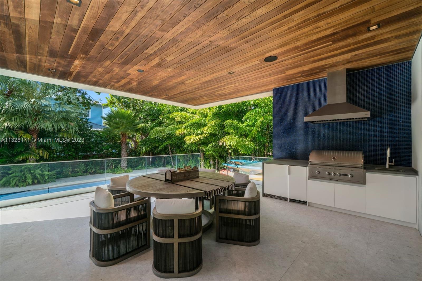 390 Pacific Road Key Biscayne, FL 33149 - Photo 27 of 37 a table and chairs sitting in backyard of a house