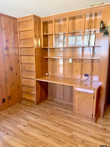 a view of a room with wooden floor and cabinet