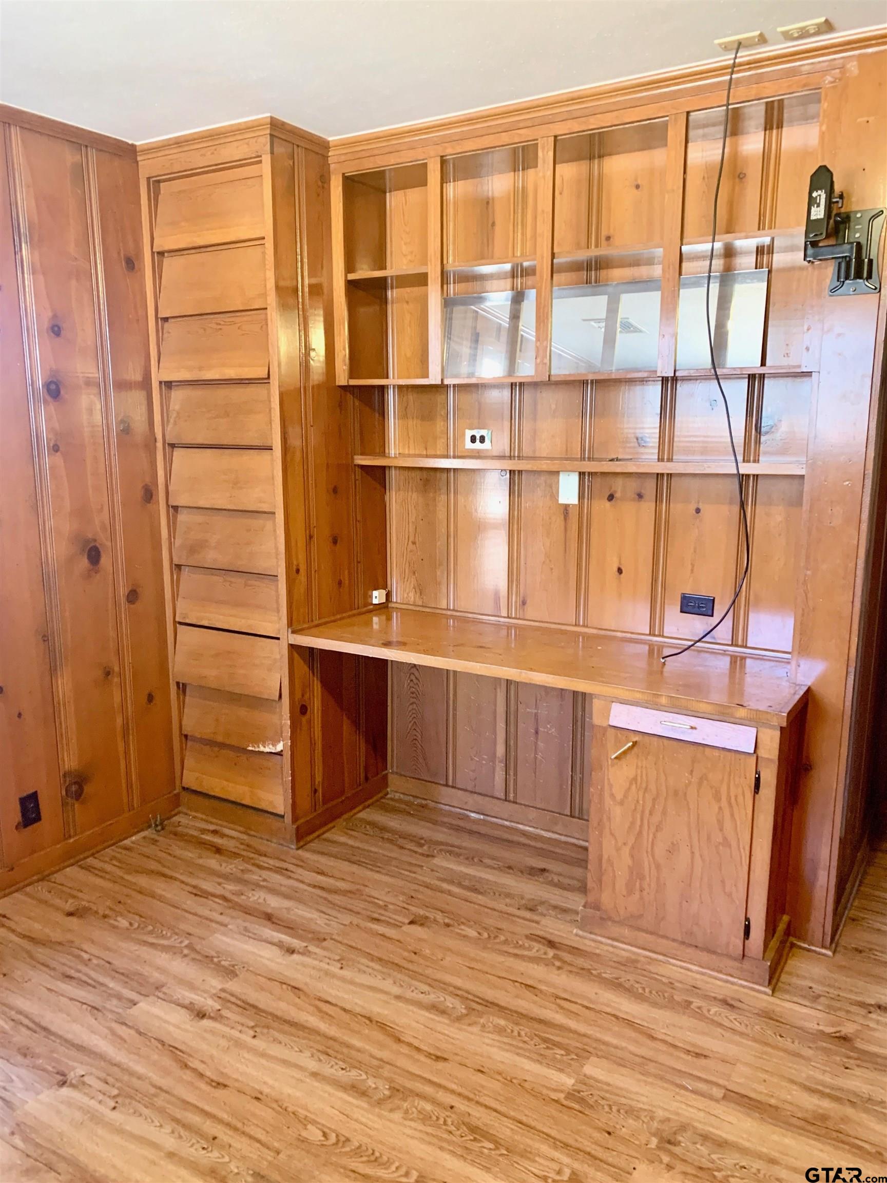 829 East Goode Street Quitman, TX 75783 - Photo 13 of 20 a view of a room with wooden floor and cabinet