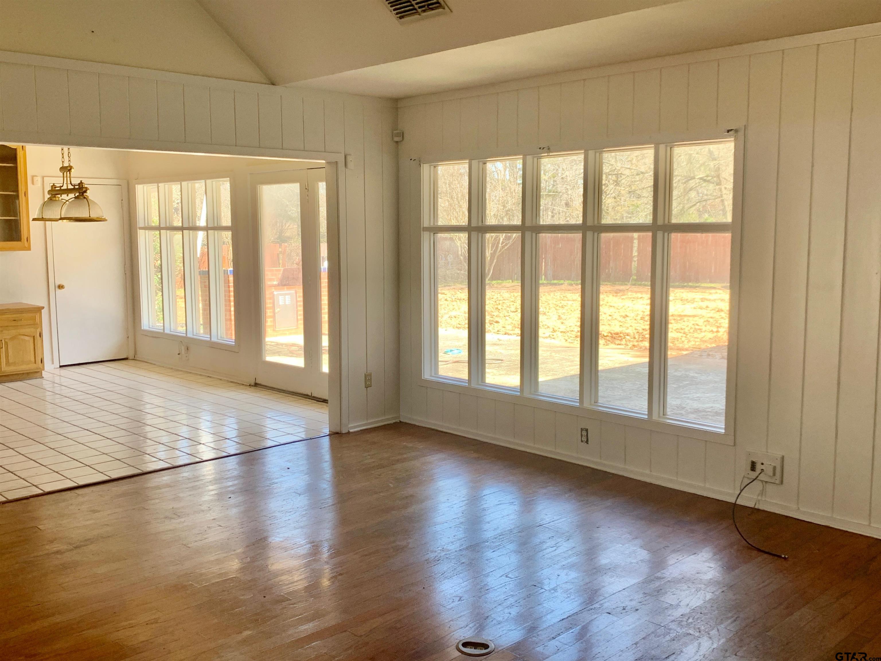 829 East Goode Street Quitman, TX 75783 - Photo 18 of 20 an empty room with wooden floor and windows