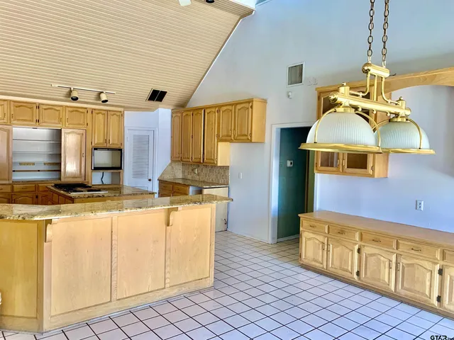 a kitchen with stainless steel appliances granite countertop a sink and cabinets