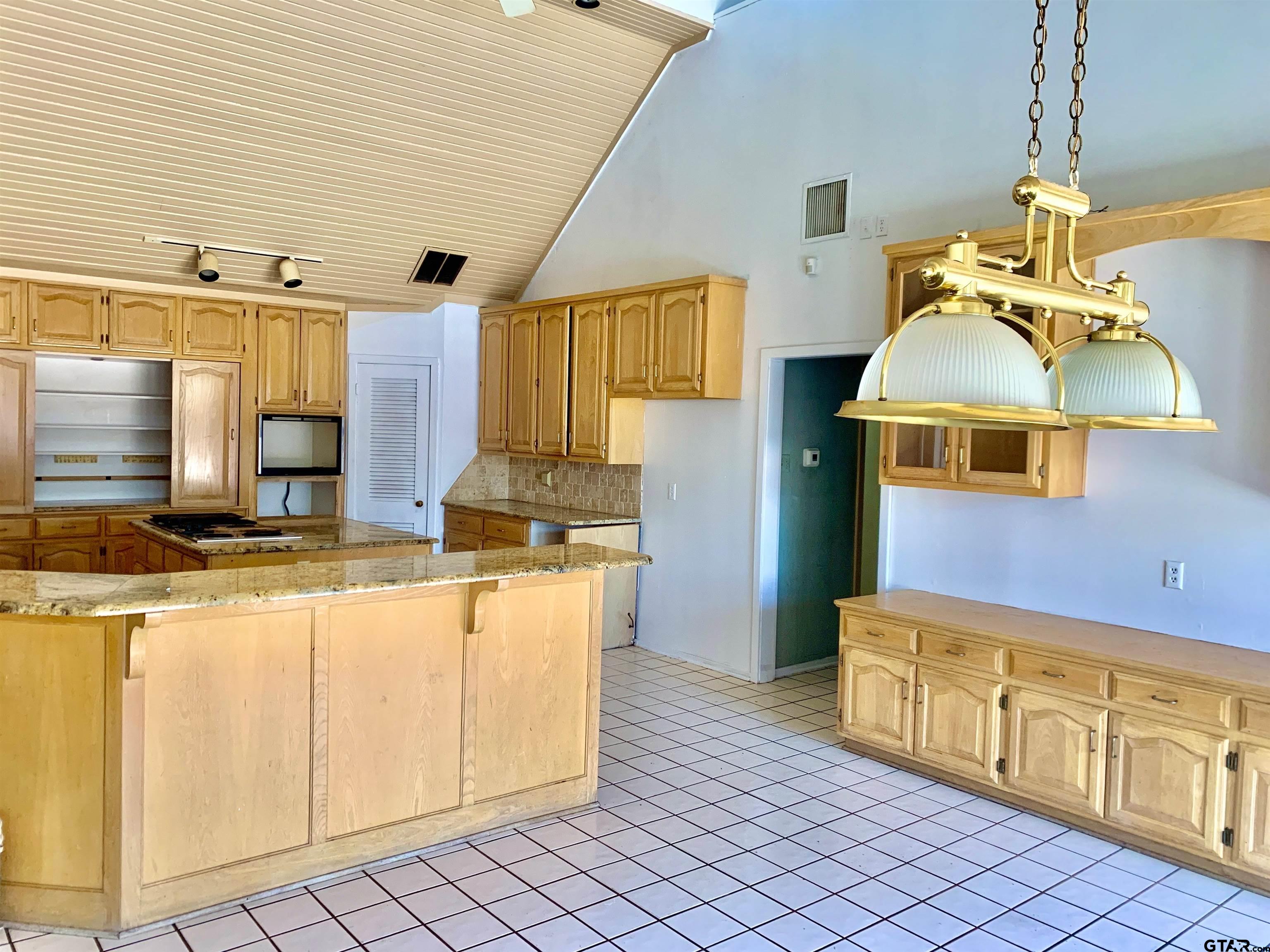 829 East Goode Street Quitman, TX 75783 - Photo 2 of 20 a kitchen with stainless steel appliances granite countertop a sink and cabinets