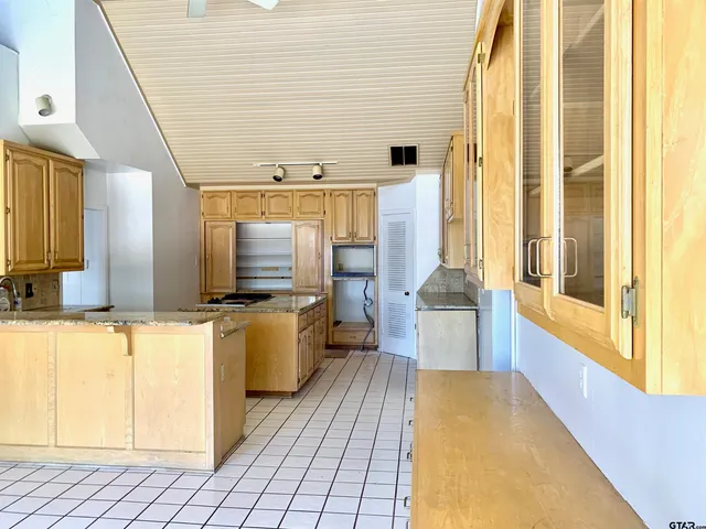 a large bathroom with a tub and window