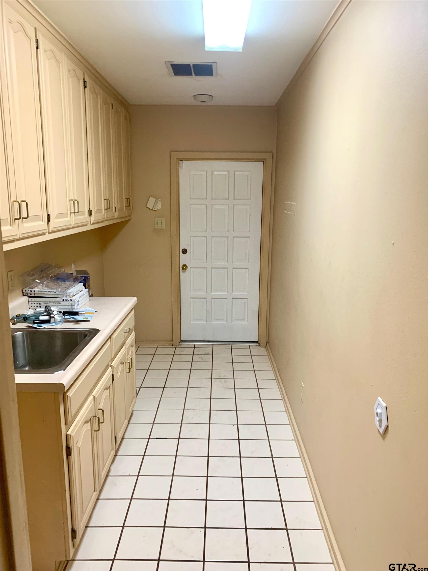 829 East Goode Street Quitman, TX 75783 - Photo 7 of 20 a bathroom with a sink a vanity and a window