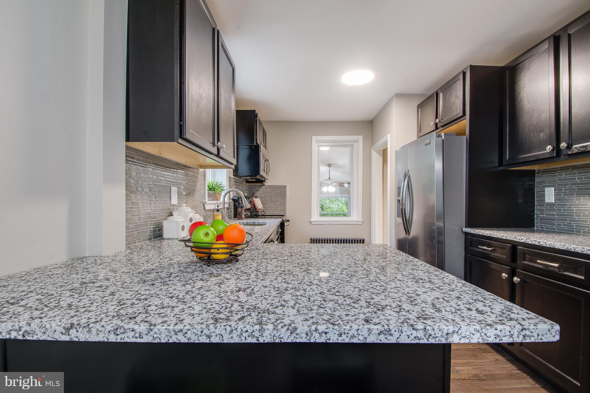 7827 Oakleigh Road Baltimore, MD 21234 - Photo 8 of 28 a kitchen with stainless steel appliances granite countertop a sink refrigerator and microwave