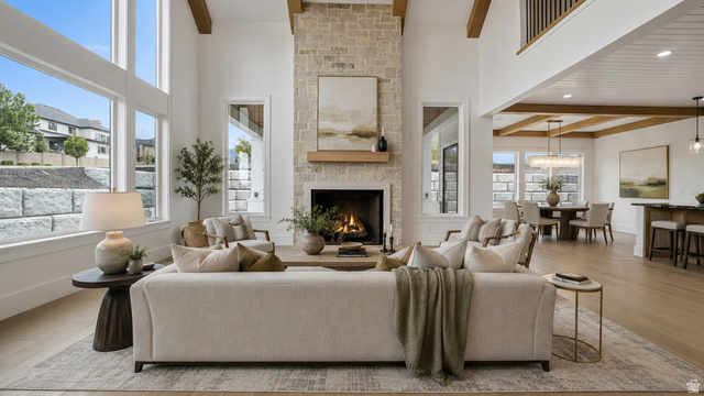 1682 North 1950 W Street, Unit 9 Provo, UT 84604 - Photo 76 of 84 Great room with a stone-clad fireplace and wood mantle, featuring high ceilings with exposed wood beams