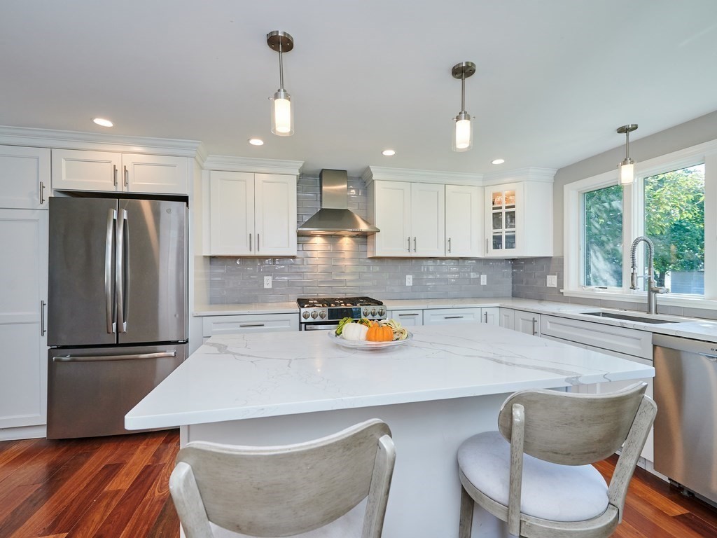 14 Hanson Street Wakefield, MA 01880 - Photo 12 of 32 a kitchen with a refrigerator a sink and a stove
