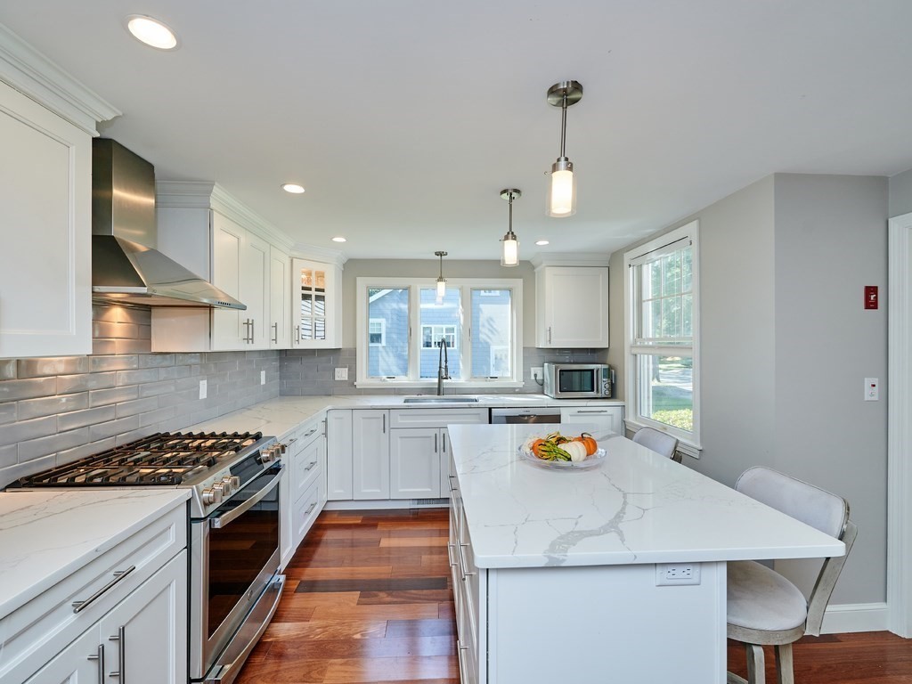14 Hanson Street Wakefield, MA 01880 - Photo 13 of 32 a kitchen with a sink stove and refrigerator
