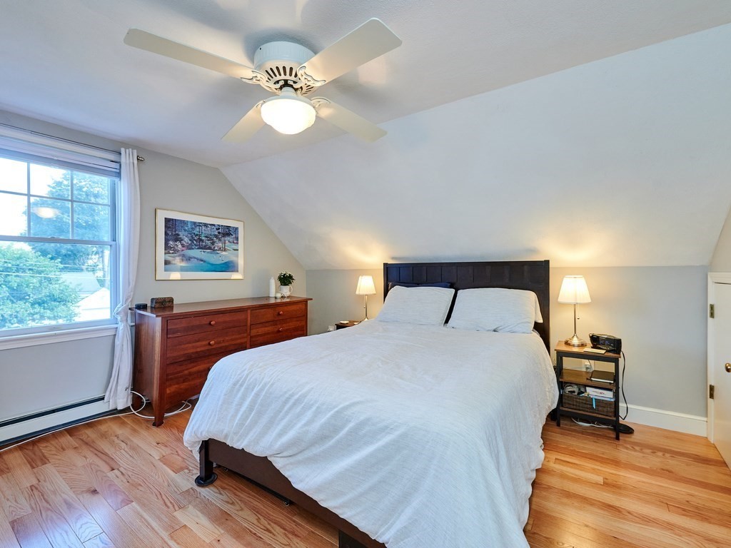 14 Hanson Street Wakefield, MA 01880 - Photo 22 of 32 a bedroom with a bed and a chandelier