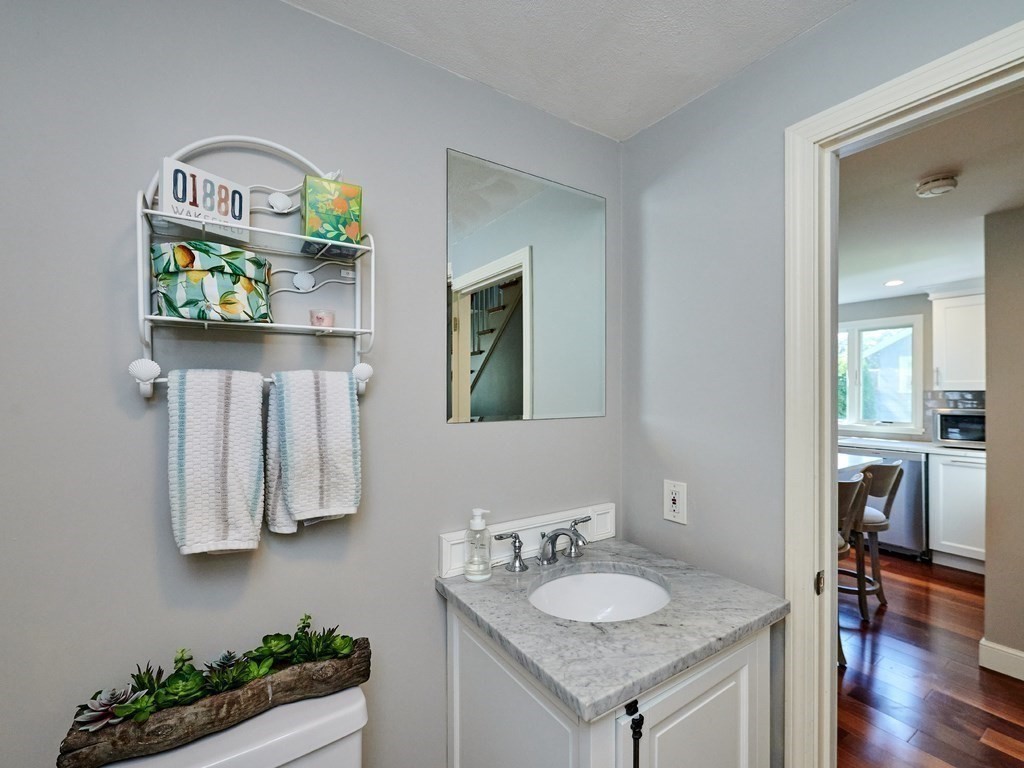 14 Hanson Street Wakefield, MA 01880 - Photo 26 of 32 a bathroom with a granite countertop sink and a mirror