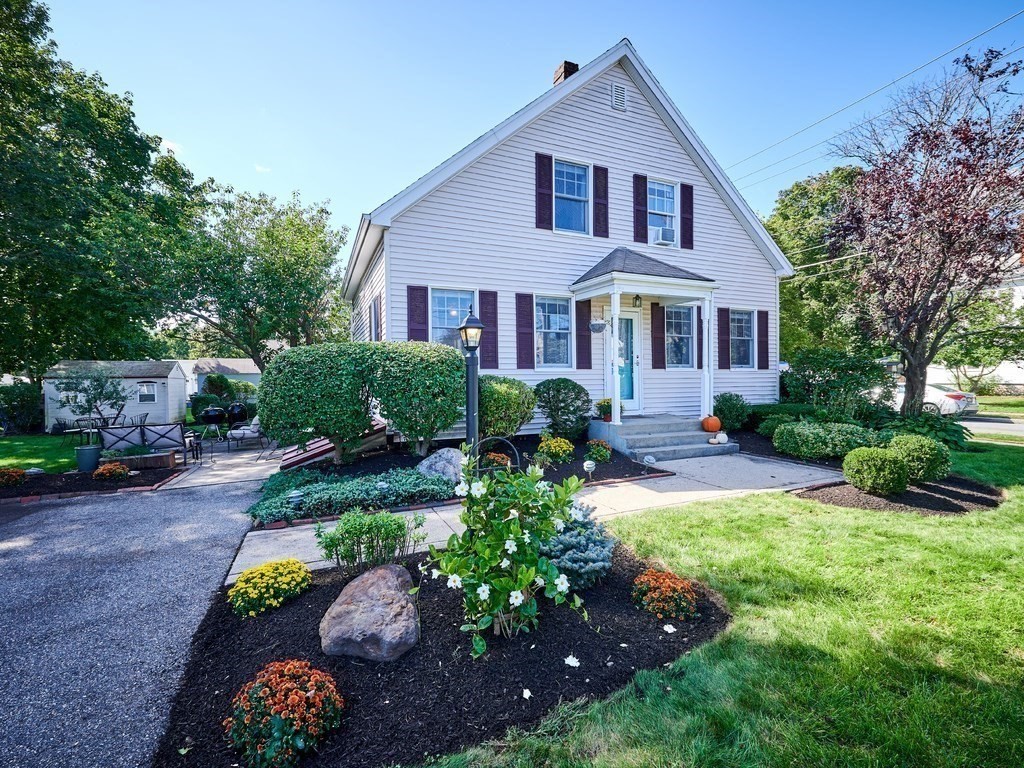 14 Hanson Street Wakefield, MA 01880 - Photo 3 of 32 a front view of a house with a yard and a garden