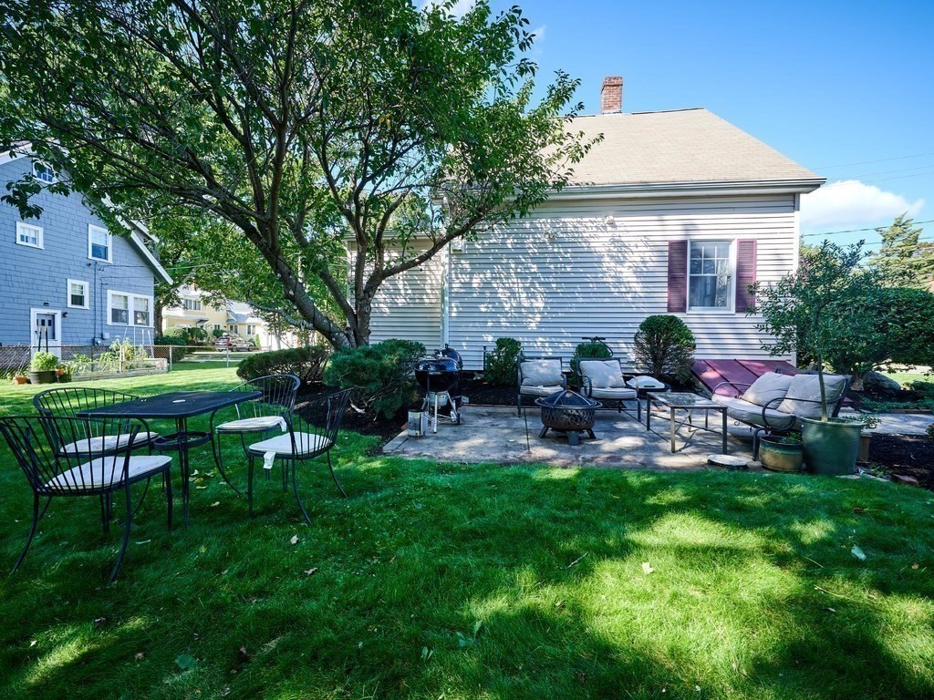14 Hanson Street Wakefield, MA 01880 - Photo 5 of 32 a view of backyard of house with outdoor seating and green space