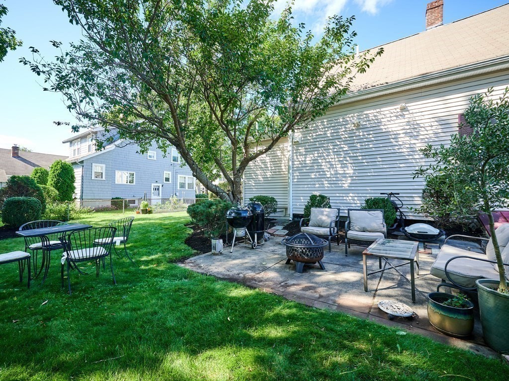 14 Hanson Street Wakefield, MA 01880 - Photo 7 of 32 a view of a patio with table and chairs potted plants and large tree