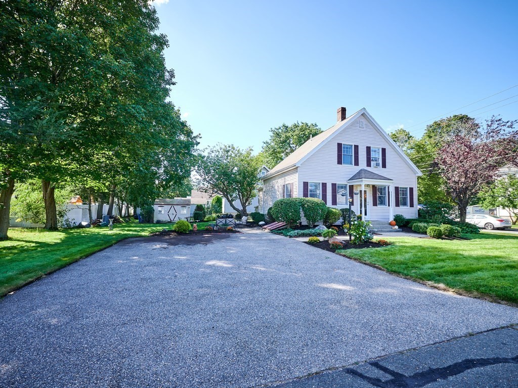 14 Hanson Street Wakefield, MA 01880 - Photo 10 of 32 a front view of a house with a yard and pathway