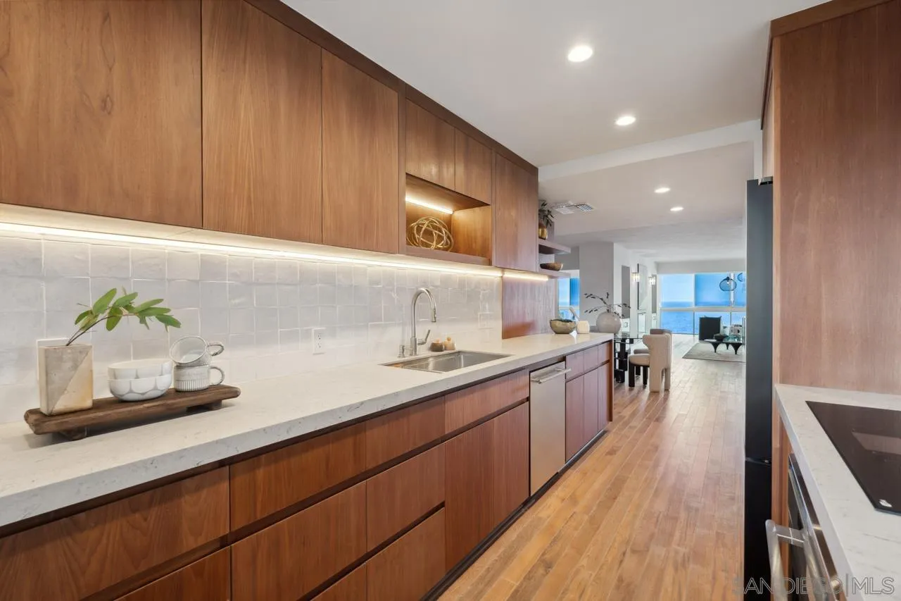 939 Coast Boulevard, Unit 12C La Jolla, CA 92037 - Photo 11 of 41 a kitchen with lots of counter space and wooden floor