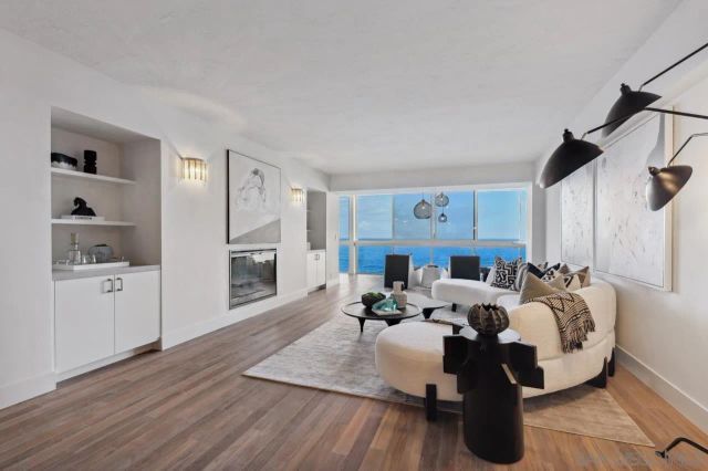 a living room with furniture fireplace and a window