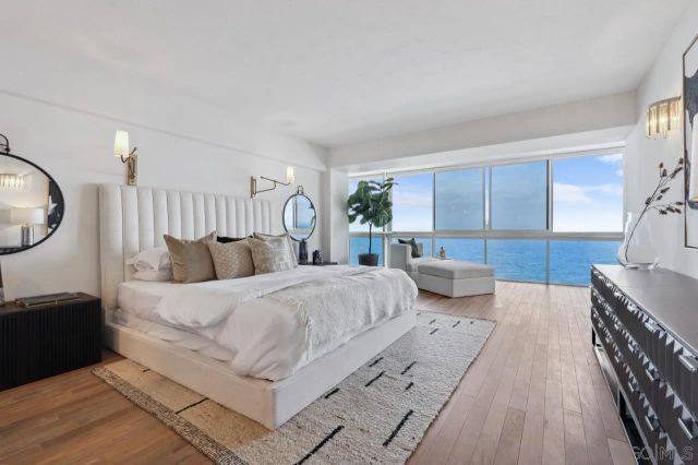 a bedroom with bed and a large mirror