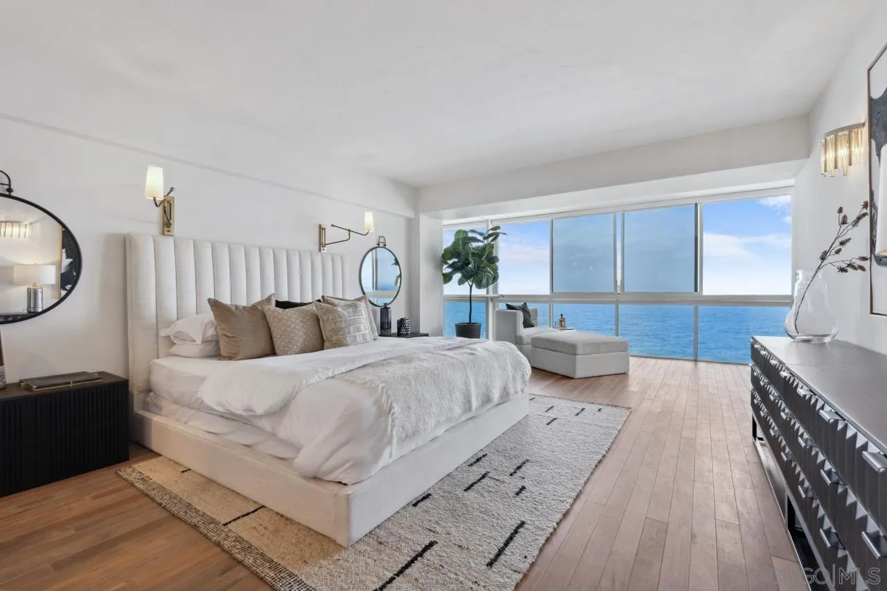 939 Coast Boulevard, Unit 12C La Jolla, CA 92037 - Photo 26 of 41 a spacious bedroom with a bed a mirror and lamp