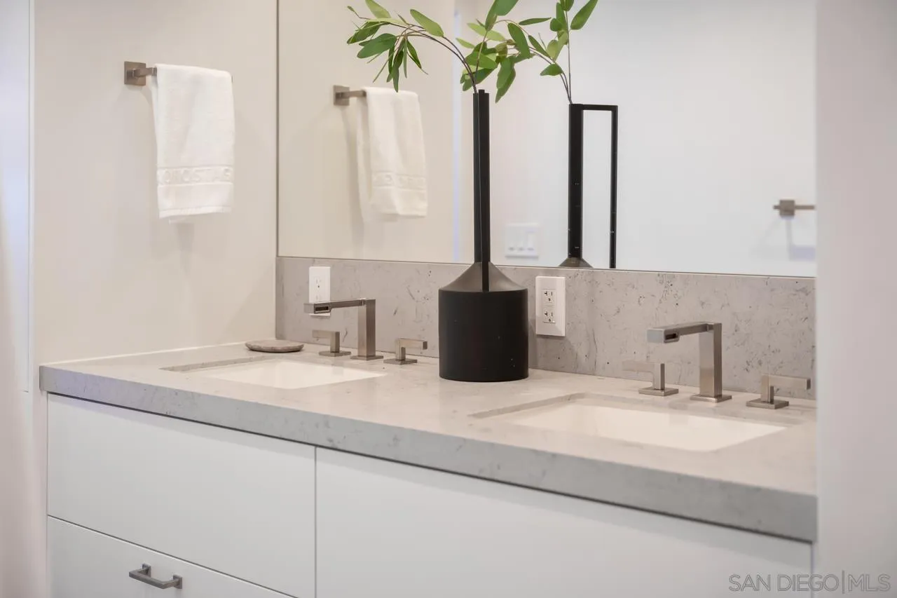 939 Coast Boulevard, Unit 12C La Jolla, CA 92037 - Photo 31 of 41 a bathroom with a granite countertop sink a vanity and a mirror