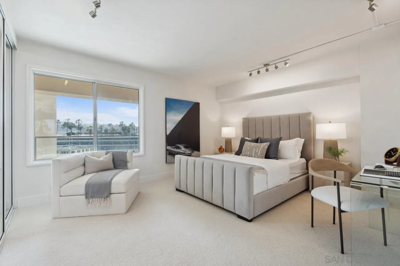 939 Coast Boulevard, Unit 12C La Jolla, CA 92037 - Photo 36 of 41 a spacious bedroom with a bed and a couch