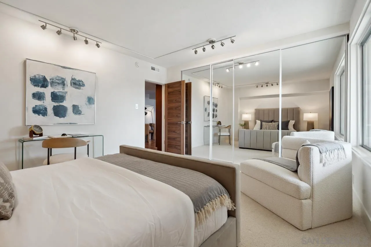 939 Coast Boulevard, Unit 12C La Jolla, CA 92037 - Photo 38 of 41 a spacious bedroom with a bed a couch and a window