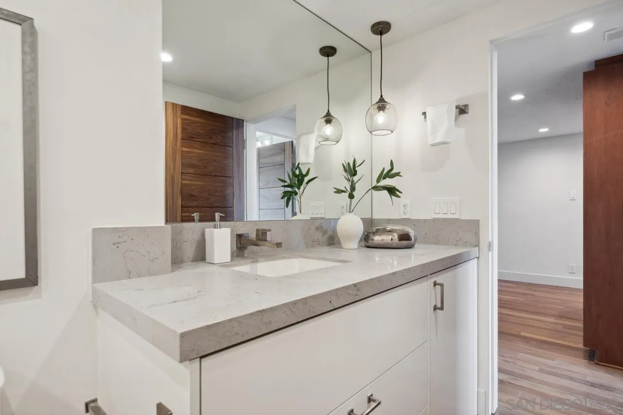 939 Coast Boulevard, Unit 12C La Jolla, CA 92037 - Photo 40 of 41 a bathroom with a sink vanity and a mirror