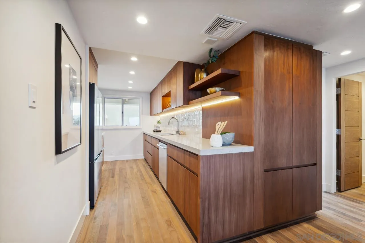 939 Coast Boulevard, Unit 12C La Jolla, CA 92037 - Photo 5 of 41 a kitchen with stainless steel appliances granite countertop a refrigerator a sink and a stove