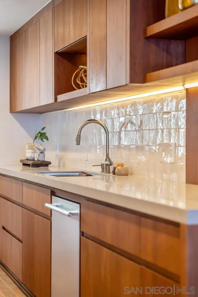 939 Coast Boulevard, Unit 12C La Jolla, CA 92037 - Photo 9 of 41 a kitchen with a sink and cabinets