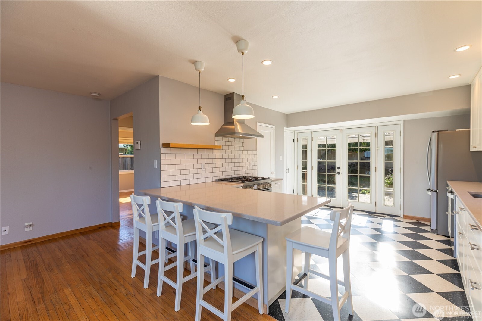 8601 36th Avenue Southwest Seattle, WA 98126 - Photo 7 of 28 a large white kitchen with a table and chairs