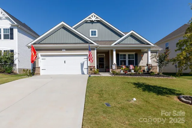 a front view of a house with a yard and a garage