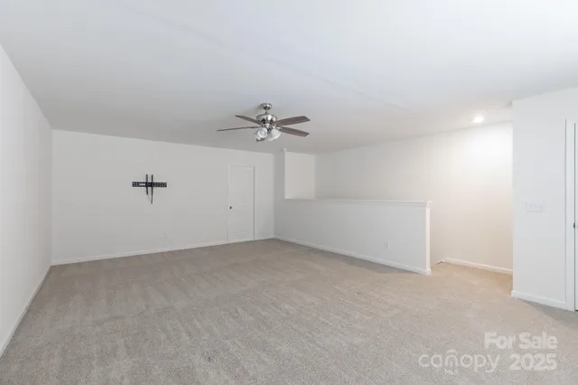 an empty room with a empty space and a ceiling fan