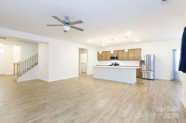 a view of a kitchen with wooden floor and a sink