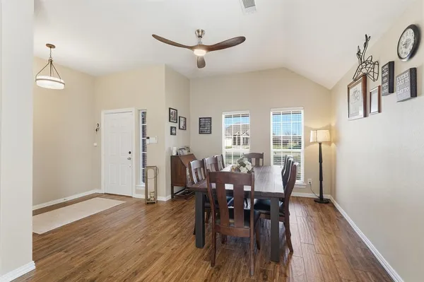 a dining room with furniture and wooden floor