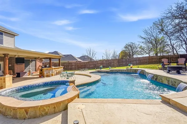 a view of a swimming pool with an outdoor seating