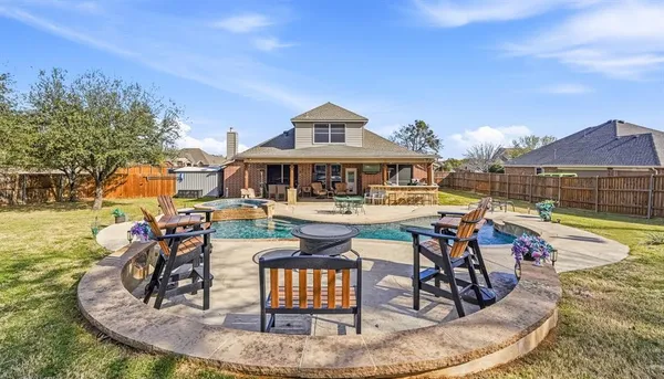 a view of a swimming pool with outdoor seating