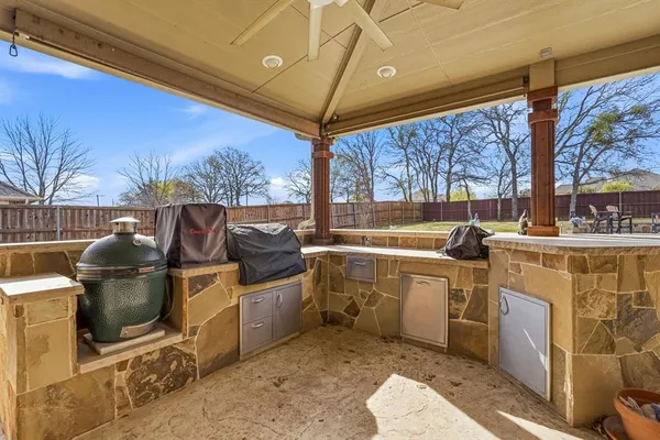 a kitchen with wooden cabinets a sink dishwasher and a stove with wooden floor
