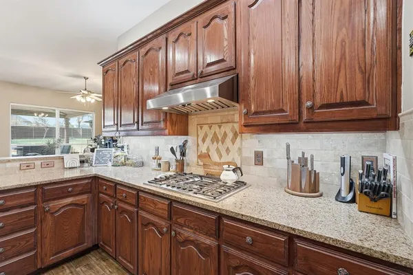 a kitchen with stainless steel appliances a refrigerator and a stove