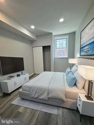 a bedroom with a bed and flat screen tv