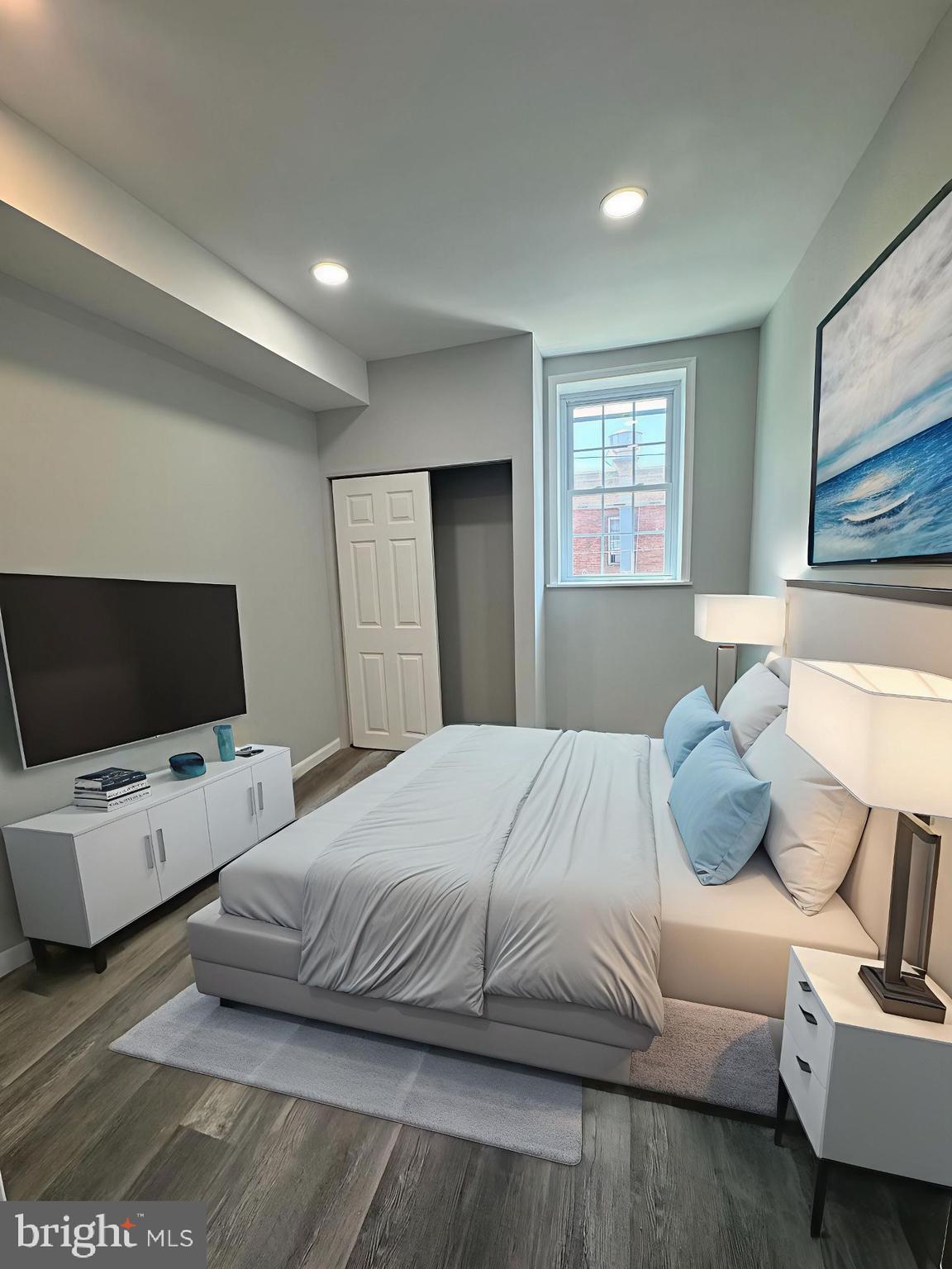 1850 South 23rd Street Philadelphia, PA 19145 - Photo 3 of 10 a bedroom with a bed and flat screen tv