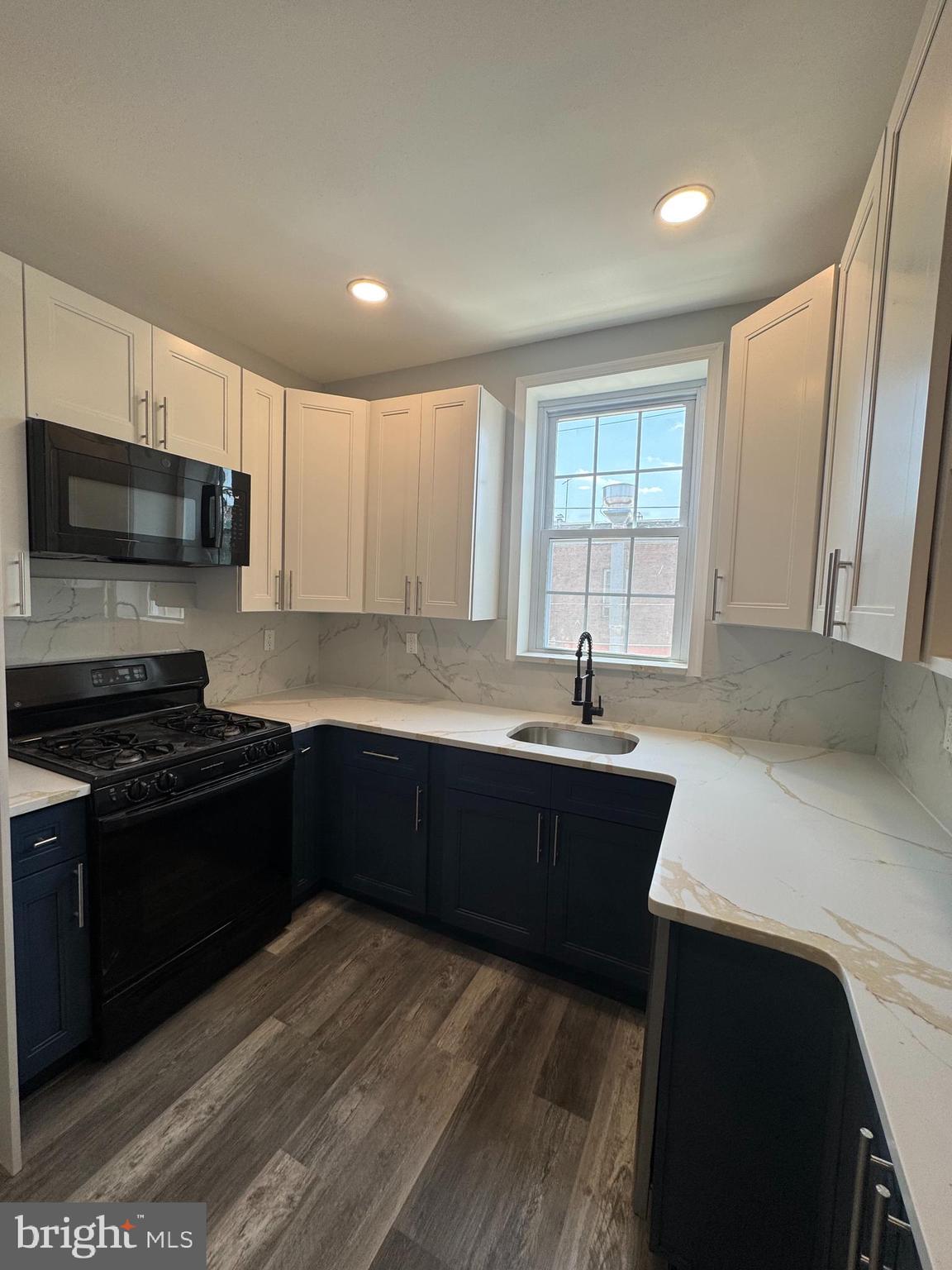 1850 South 23rd Street Philadelphia, PA 19145 - Photo 7 of 10 a kitchen with a sink and a stove top oven