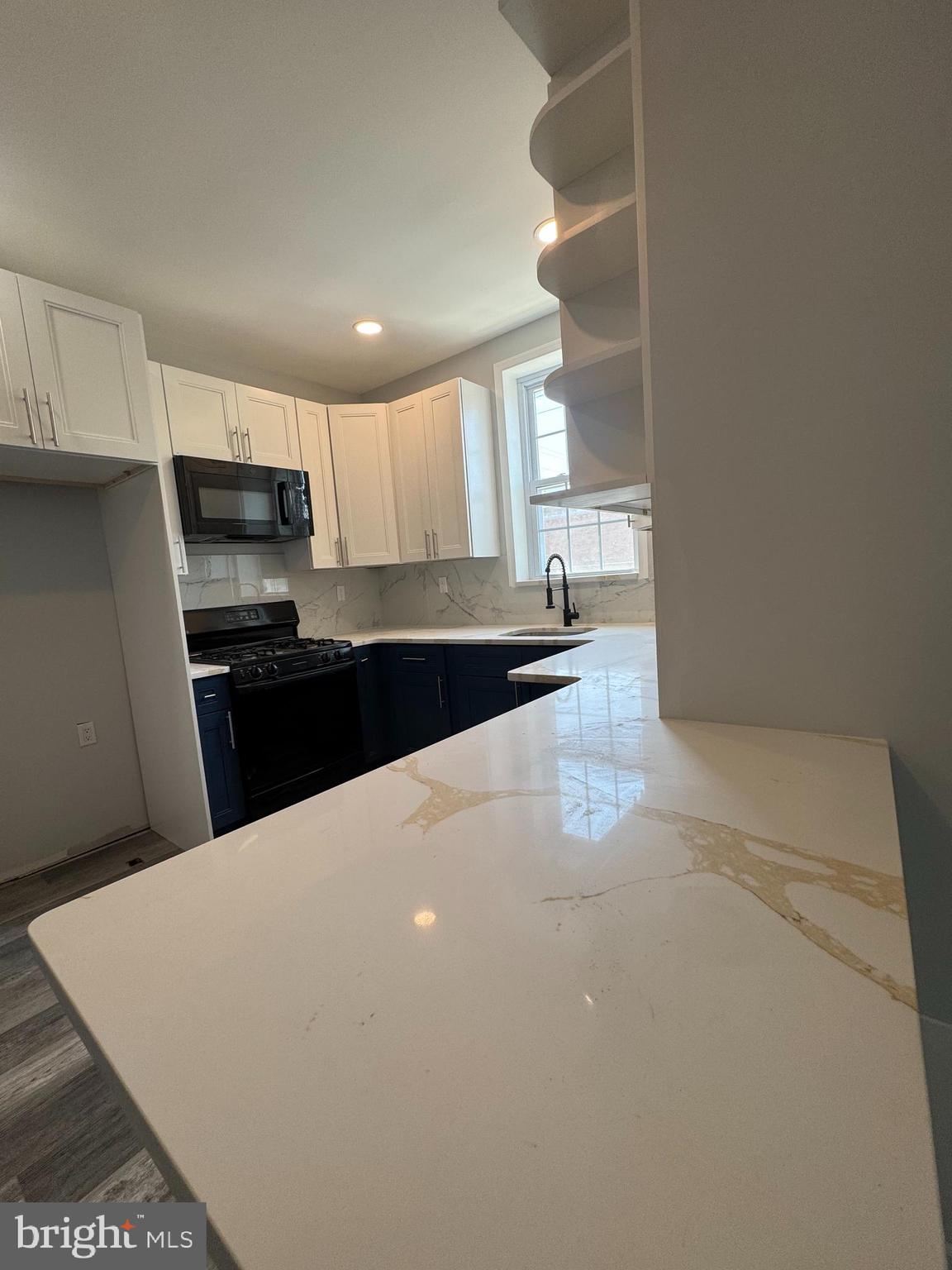 1850 South 23rd Street Philadelphia, PA 19145 - Photo 8 of 10 a kitchen with stainless steel appliances a refrigerator sink and microwave