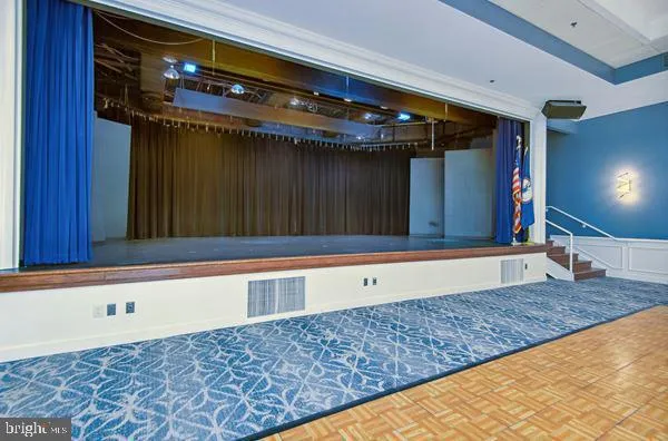 a living room with furniture and a book shelf