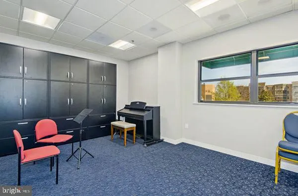 a living room with furniture a rug and a large window