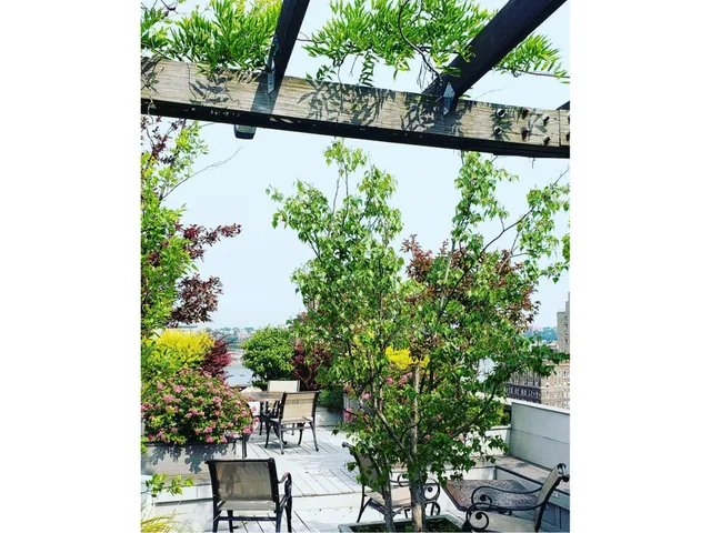 a view of a terrace with furniture and city view