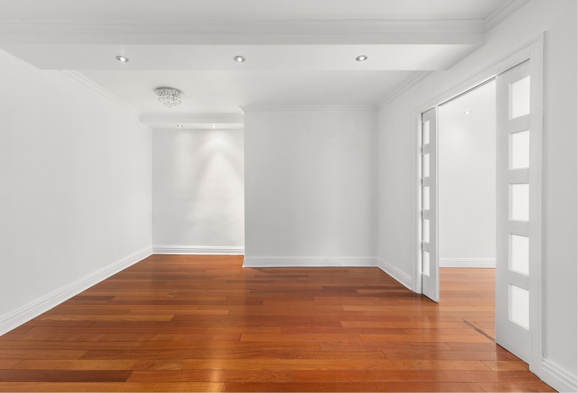 200 West 79th Street, Unit 10GH Manhattan, NY 10024 - Photo 6 of 19 a view of an empty room with wooden floor and a window