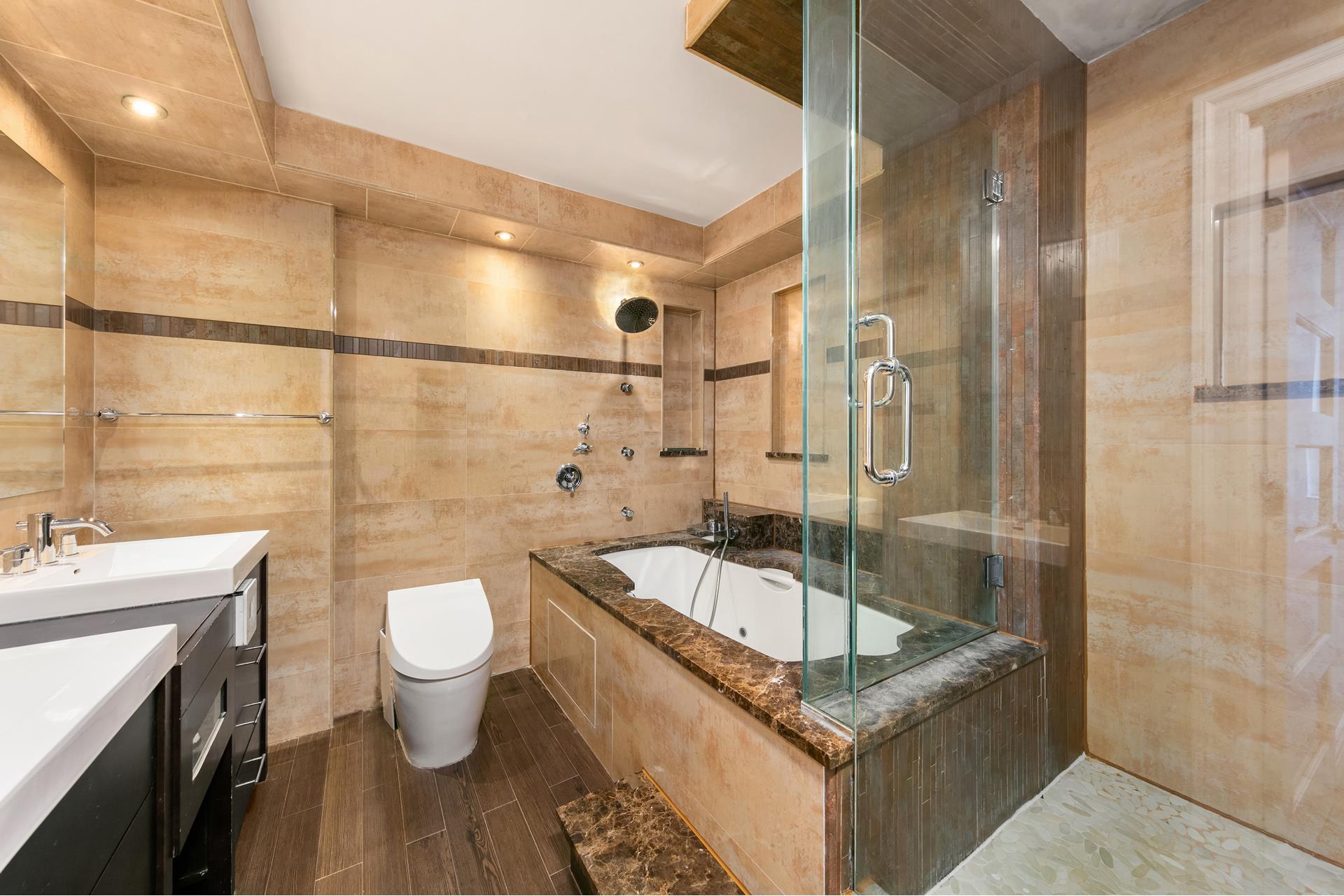 200 West 79th Street, Unit 10GH Manhattan, NY 10024 - Photo 9 of 19 a bathroom with a granite countertop sink a toilet a mirror and shower