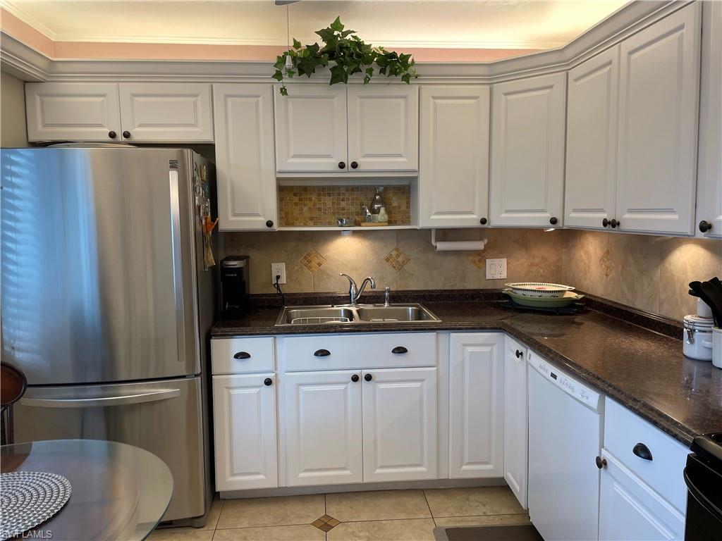 541 Teryl Road, Unit 1 Naples, FL 34112 - Photo 1 of 33 a kitchen with stainless steel appliances granite countertop a refrigerator a stove a sink and white cabinets